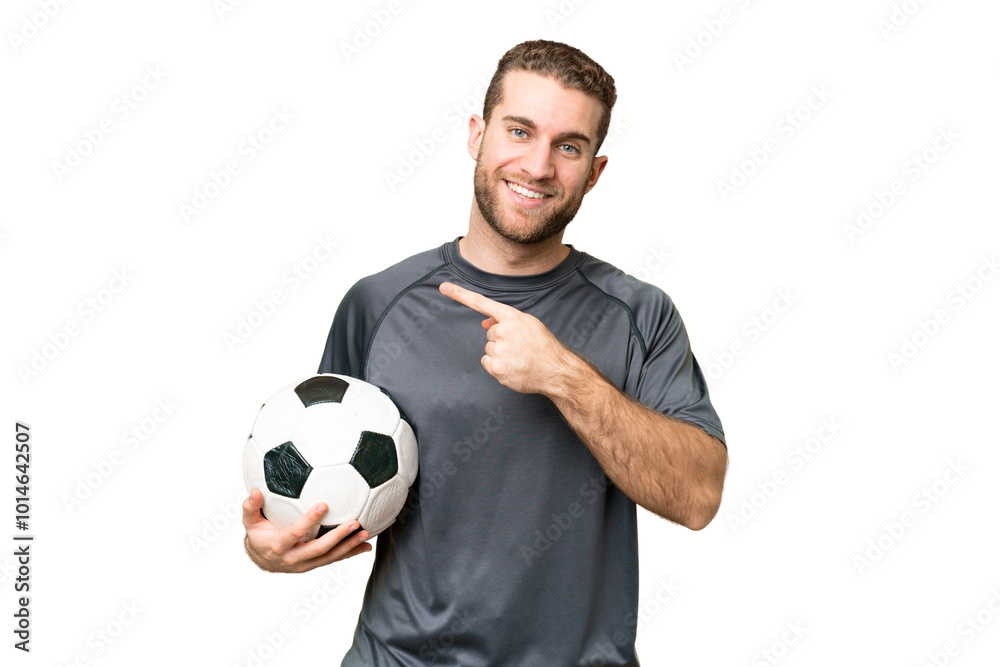 Young handsome blonde man over isolated chroma key background with soccer ball and pointing to the lateral Young handsome blonde man over isolated chroma key background with soccer ball and pointing to the lateral