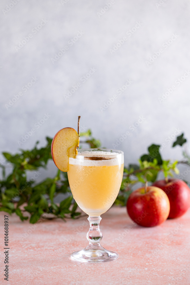 Apple cider cocktail with cinnamon and apple slice garnish Apple cider cocktail with cinnamon and apple slice garnish