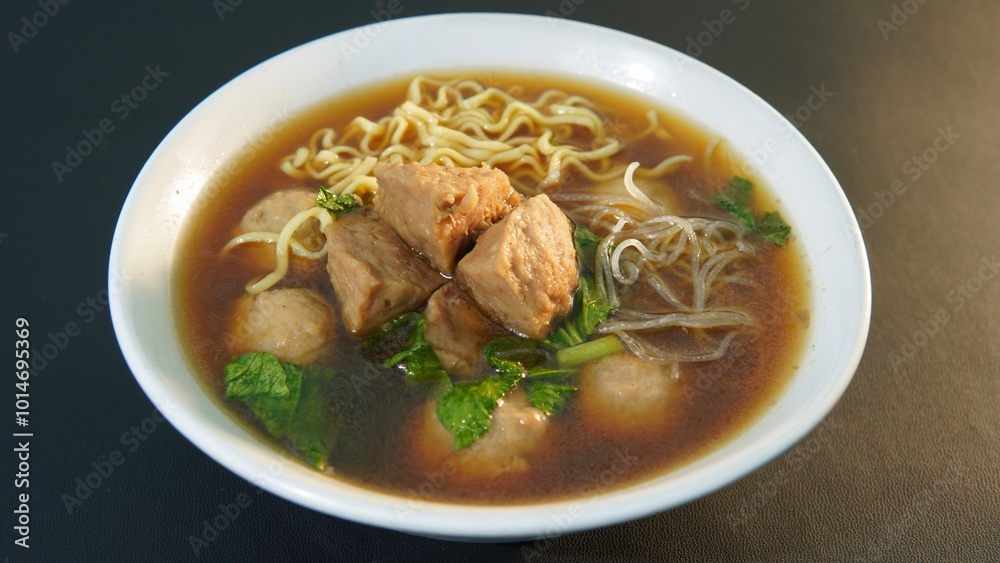 a typical Indonesian food called Bakso or Baso in a bowl on a black background a typical Indonesian food called Bakso or Baso in a bowl on a black background