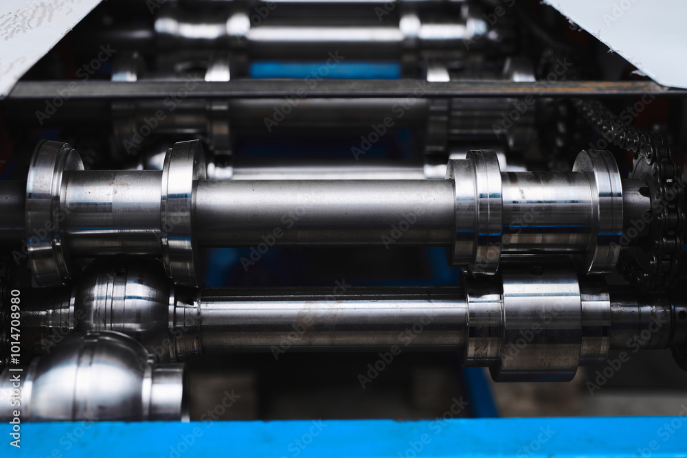 Rolled metal, metal processing and manufacturing of metal fence, close-up of metal rolling equipment at the factory Rolled metal, metal processing and manufacturing of metal fence, close-up of metal rolling equipment at the factory