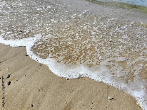 Natural seawater foam on the beach