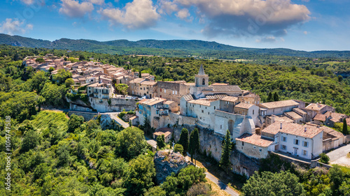 View of Venasque village with old church Notre Dame de Vie to landscape of Luberons, Provence, France. Beautiful Church and houses in the town of Venasque, Provence, France.