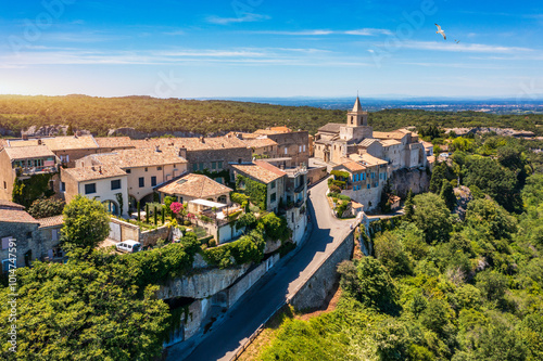 View of Venasque village with old church Notre Dame de Vie to landscape of Luberons, Provence, France. Beautiful Church and houses in the town of Venasque, Provence, France.