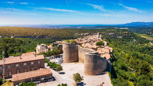 View of Venasque village with old church Notre Dame de Vie to landscape of Luberons, Provence, France. Beautiful Church and houses in the town of Venasque, Provence, France.