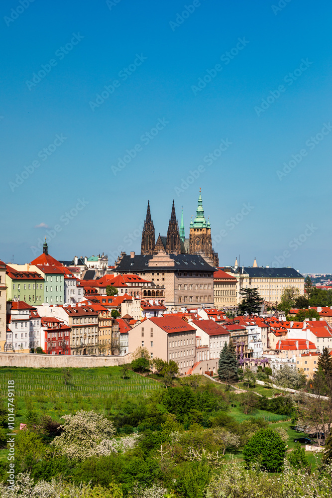 Panoramic view of Prague featuring historic castle and vibrant rooftops on a sunny day in summer. View of Prague, Czech Republic, showcasing the city's iconic architecture and red-tiled roofs. Panoramic view of Prague featuring historic castle and vibrant rooftops on a sunny day in summer. View of Prague, Czech Republic, showcasing the city's iconic architecture and red-tiled roofs.