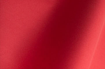 Red paper background with a smooth texture, perfect for Christmas cards, luxury products, or elegant