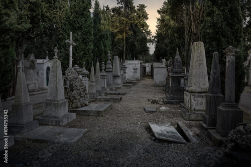 Creepy old cemetery at dark sunset photo