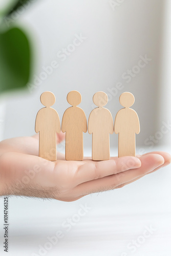 Person holding wooden figures representing family dynamics in systemic constellations therapy session