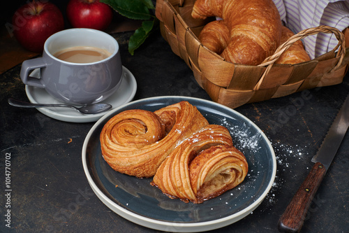 Franzbrötchen an original sweet pastry from Hamburg with a cup of latte