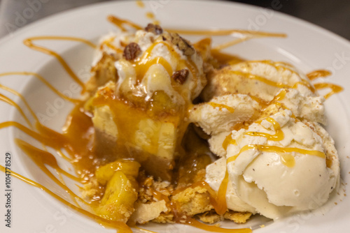 Cheese cake, bananas, caramel dessert. Making dessert behind the scenes. Vanilla Ice cream, whip cream topped on cheese cake, banana sauce topping with caramel on top. 