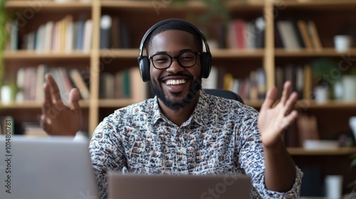 A person wearing headphones sits in front of a laptop, possibly working or gaming