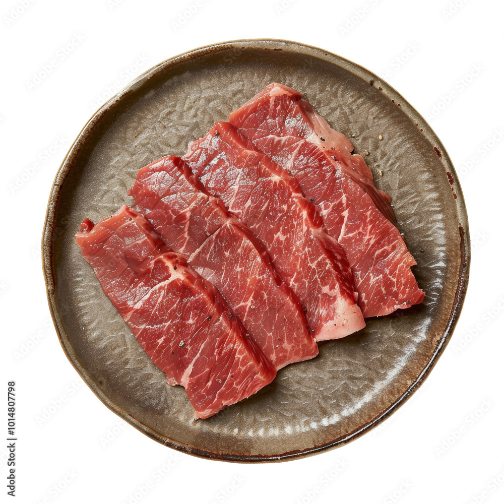 Fototapeta premium Freshly Cut Raw Beef Slices Arranged on a Round Plate.