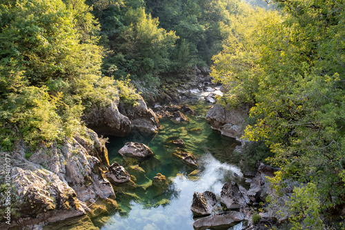 View over a crystal clear mountain river from Old brick bridge called Danilov most at Mrtvica canyon in Montenegro