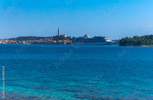 A huge tourist ship enters the port of Rovinj, sailing on the Adriatic Sea on a cruiser photo