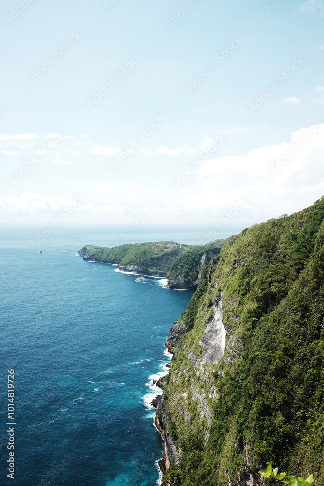 Landscape of wave crashing rocky cliff and wild on stone mountain at the blue calm sea with sponge on summer with ocean for destination in Bali island at Indonesia Landscape of wave crashing rocky cliff and wild on stone mountain at the blue calm sea with sponge on summer with ocean for destination in Bali island at Indonesia