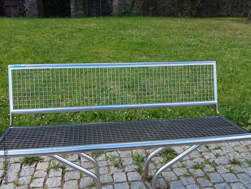 beautiful modern metal bench in the park
