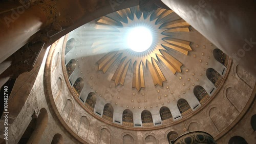 A remarkable phenomena caused by the light beam, penetrating the inside dome at the Church of the Holy Sepulchre. a wide angle shot inside the holy Church. a 4K clip, July 2nd, 2024, Jerusalem, Israel