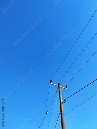 Low angle view electricity pylon against clear sky, Subang, Indonesia photo