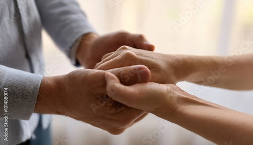 Two hands clasping each other, symbolizing connection, support, and emotional bonds between individuals. 