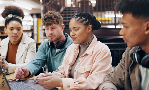 People, university student and group work with laptop at library for research, assignment and project. Classmates, friends and serious as college learner on campus for revision, studying or teamwork