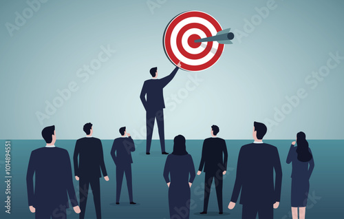 Leadership and business target concept. Businessman leading a group of people pointing at a target.