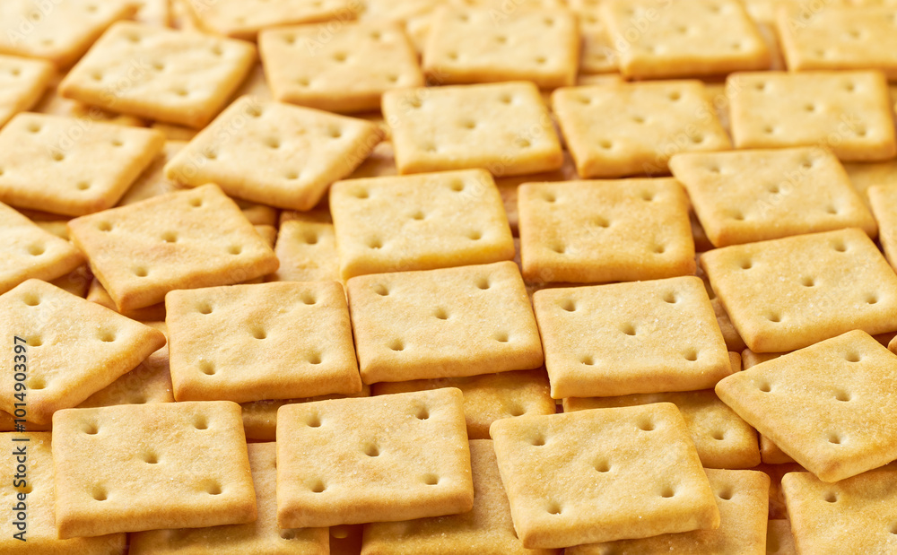 Square crackers placed throughout the screen selective focus. Food background. Square crackers placed throughout the screen selective focus. Food background.