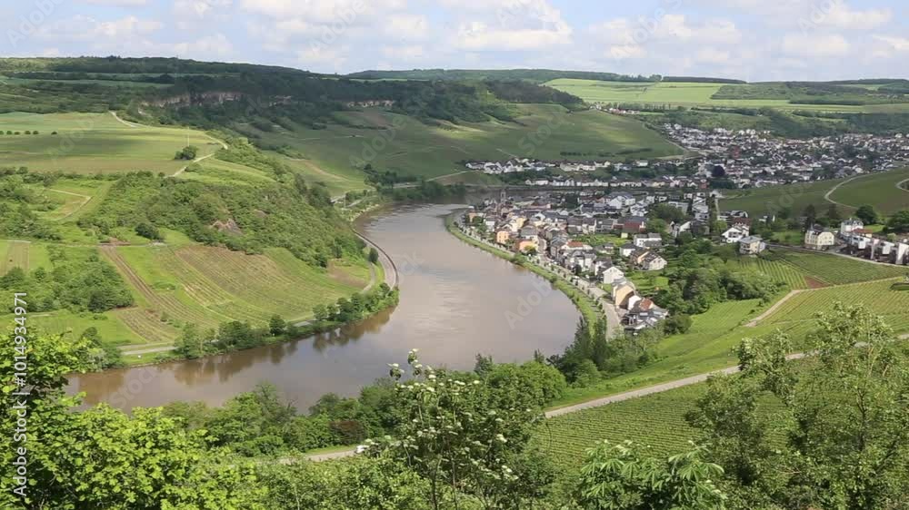 View from Grevenmacher vineyards in Luxembourg onto landscape with Moselle River and the towns of Machtum and Nittel on a sunny day View from Grevenmacher vineyards in Luxembourg onto landscape with Moselle River and the towns of Machtum and Nittel on a sunny day