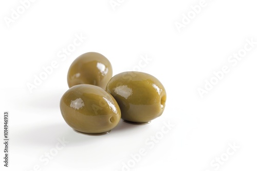 Close-up shot of three green olives on a white background