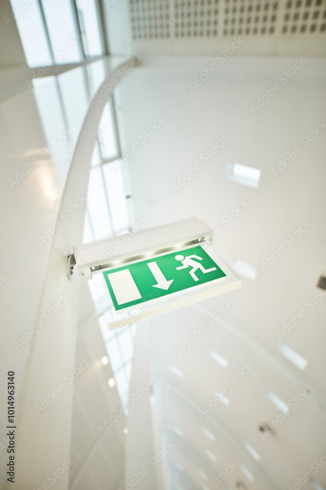 Fire escape, texture and exit sign as background or wallpaper in corridor or office building. Symbol, guideline and below with safety, information and arrow for directions, emergency icon or warning Fire escape, texture and exit sign as background or wallpaper in corridor or office building. Symbol, guideline and below with safety, information and arrow for directions, emergency icon or warning