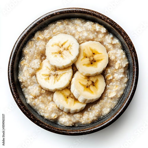 A bowl of oatmeal with banana slices on top. photo