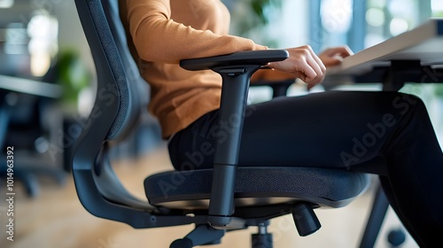 Person Adjusting Office Chair for Comfort and Productivity in Workspace photo