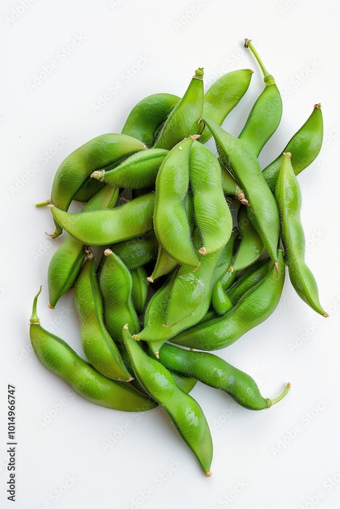 A bunch of fresh green beans arranged on a white surface A bunch of fresh green beans arranged on a white surface