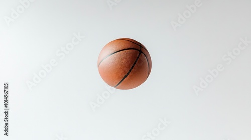 A dynamic shot of a basketball mid-air, captured against a stark white background, showcasing the excitement of the game and sportsmanship.