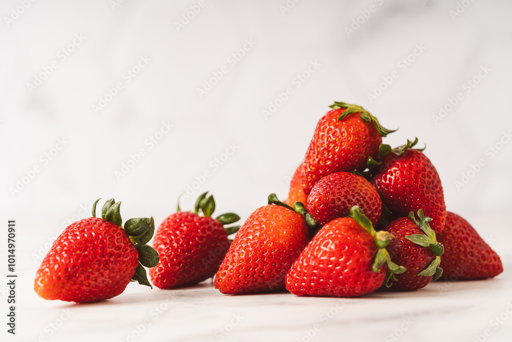 Strawberries stacked on marble counter Strawberries stacked on marble counter