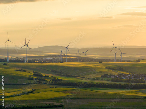 Wind Turbines in a Beautiful Landscape and Sunset Sky. Alternative electricity, sustainable resources, Renewable energy