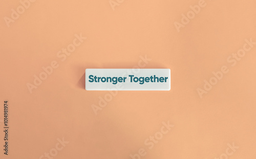 Stronger Together Phrase. Text on Block Letter Tile on Dusty Pink Background. Minimal Aesthetic.