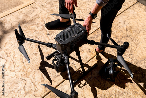 person carefully setup a large drone with eight propellers