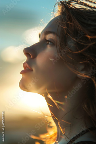 Young woman gazing at sunrise, soft light illuminating her face, serene expression of hope