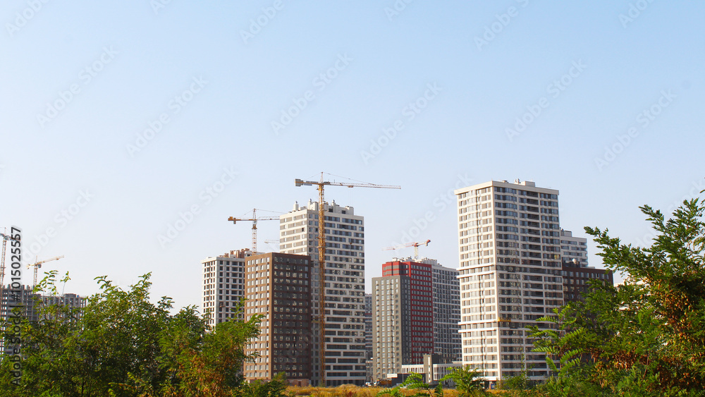 construction site with cranes, building under construction, skyscrapers in the city