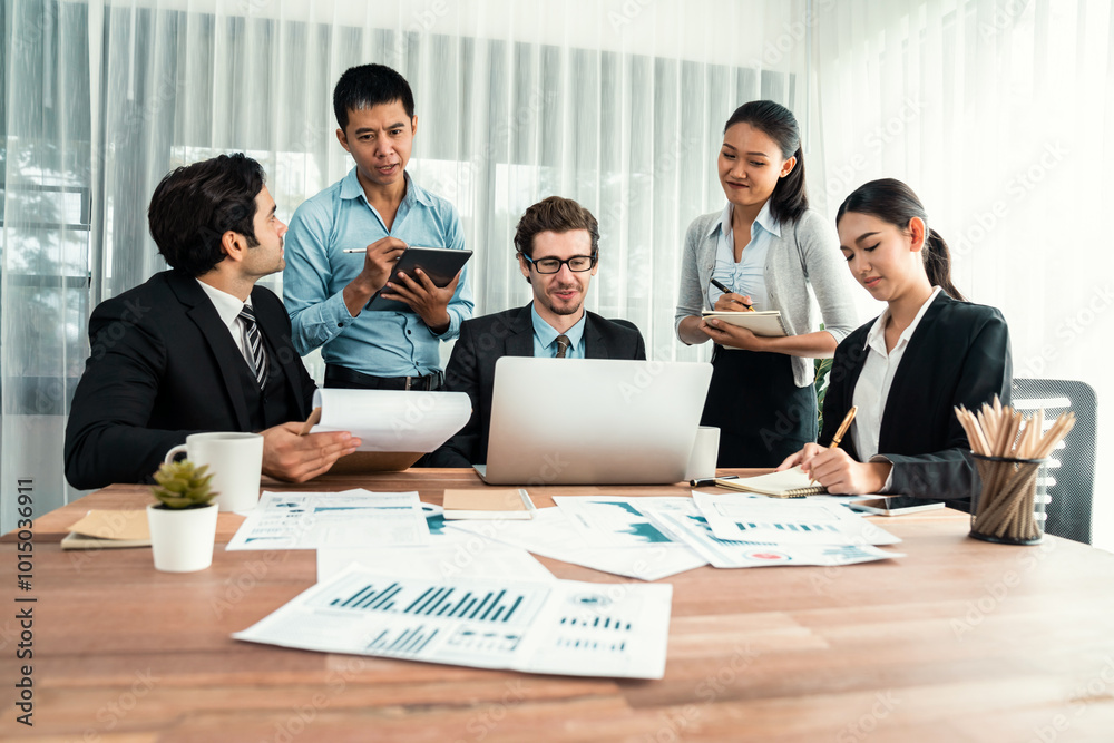 Diverse group of business analyst team analyzing financial data report paper on office table. Chart and graph dashboard by business intelligence analysis for strategic marketing planning Habiliment Diverse group of business analyst team analyzing financial data report paper on office table. Chart and graph dashboard by business intelligence analysis for strategic marketing planning Habiliment