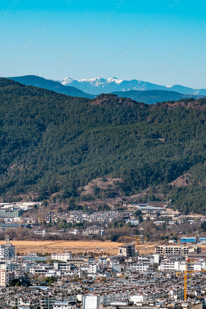Lijiang City, Yunnan Province, China and the distant mountains. Lijiang City, Yunnan Province, China and the distant mountains.