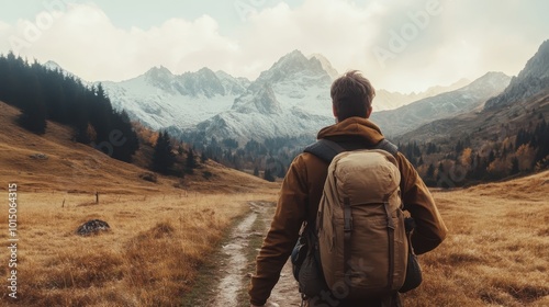 A solo hiker with a backpack walks through a vast and picturesque mountain valley at dawn, symbolizing solitude, exploration, and the beauty of untouched wilderness.