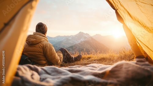 A contemplative moment where a person sits at a tent's entrance, savoring the breathtaking sunrise over the mountain horizon, suggesting serene solitude and adventure.