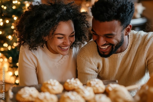 Happy couple enjoying freshly baked cookies together during the holiday season, with a Christmas tree in the background. photo