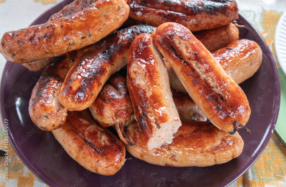 Grilled barbecue sausages on a plate, top view, close-up Grilled barbecue sausages on a plate, top view, close-up