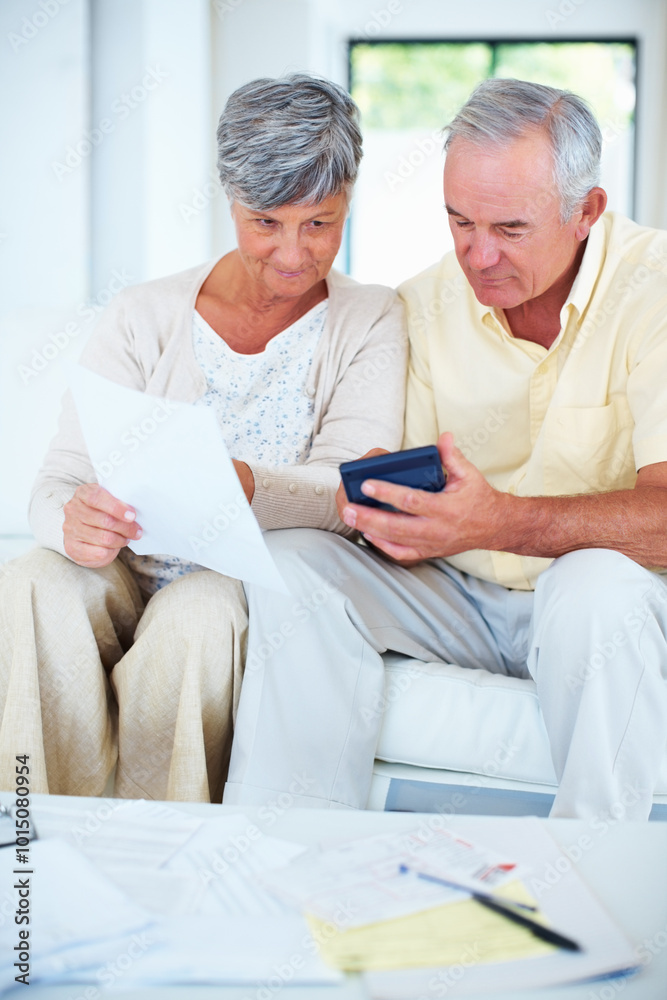 Senior, couple and paperwork with calculator in home with budget planning, asset management or discussion. Elderly, people and thinking on sofa with documents for investment account, bills or banking Senior, couple and paperwork with calculator in home with budget planning, asset management or discussion. Elderly, people and thinking on sofa with documents for investment account, bills or banking