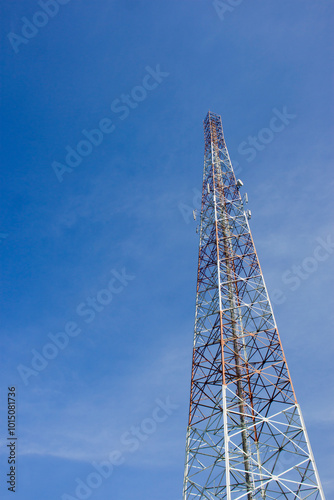 Provider transmitter mast on the side of the road with a view of the blue sky 