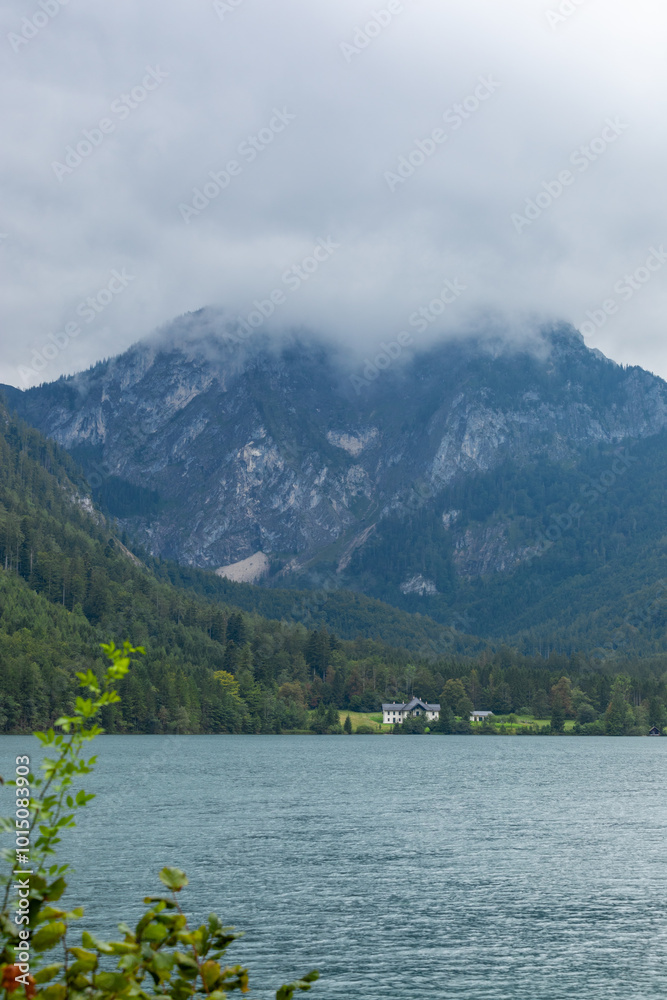 summer landscape of high mountains and a lake. The weather is cloudy and bad over the lake and surrounding mountains. summer landscape of high mountains and a lake. The weather is cloudy and bad over the lake and surrounding mountains.