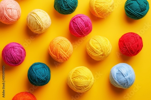 Colorful yarn balls arranged on a yellow background