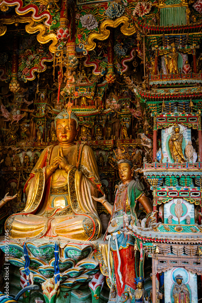 Fototapeta premium Stone statue of cross-legged Bodhisattva in Cave 18 of Yungang Grottoes, Datong, Shanxi Province